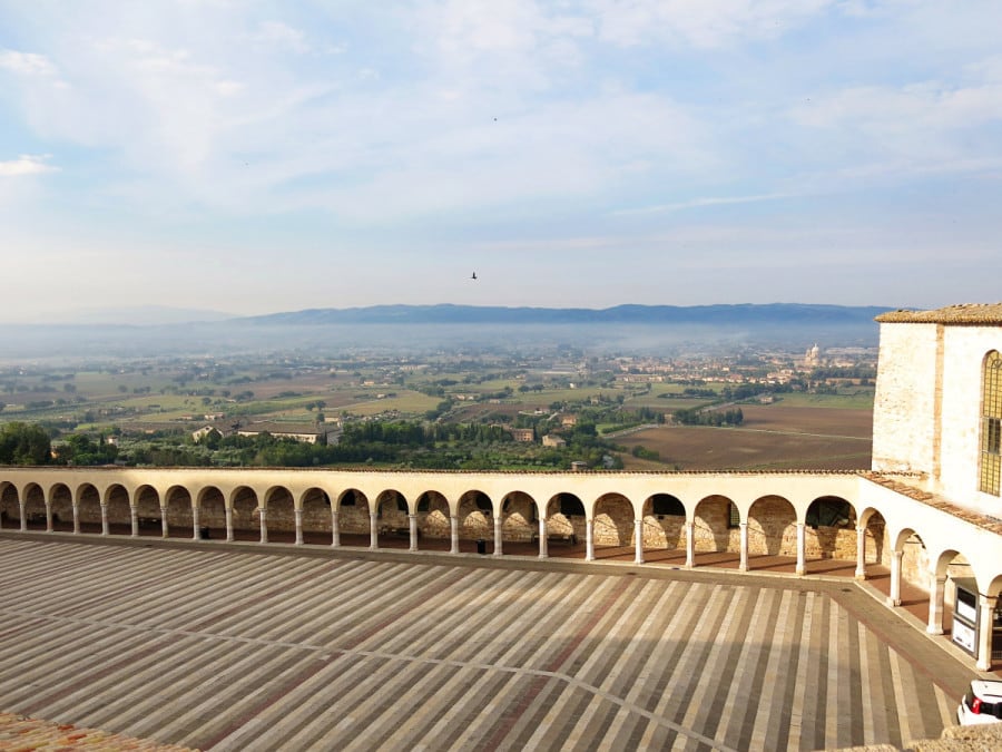 Hotel Giotto, Assisi, Italy, view of the courtyard of the cathedral, arched walkway and lands in the distance