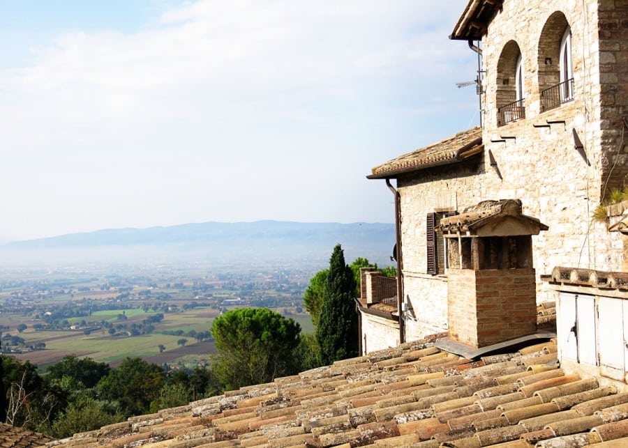 Assisi, Italy, buildings and roof tops, and lands down below in the distance