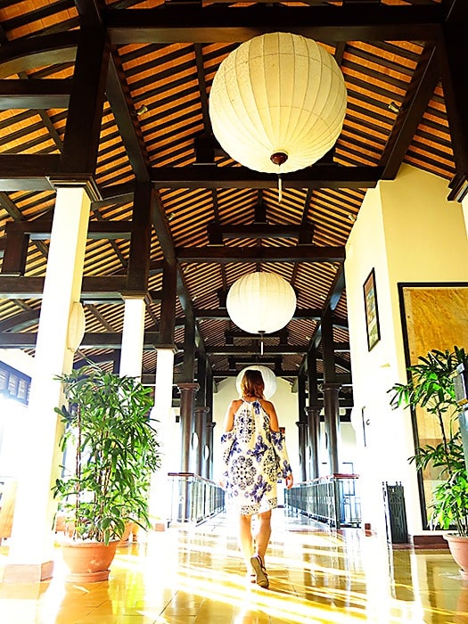 Victoria Hoi An, Vietnam, woman walking away in the hallway in the resort