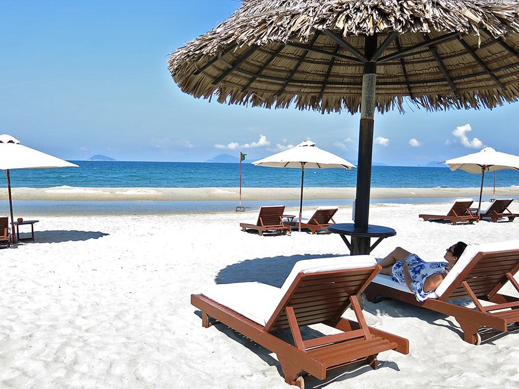 Victoria Hoi An, Vietnam, beach view, white sand, sun loungers and beach umbrellas