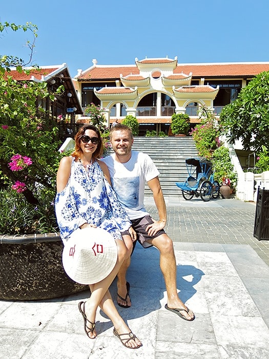 Victoria Hoi An, Vietnam, a couple sitting in front of the entrance to the resort, steps