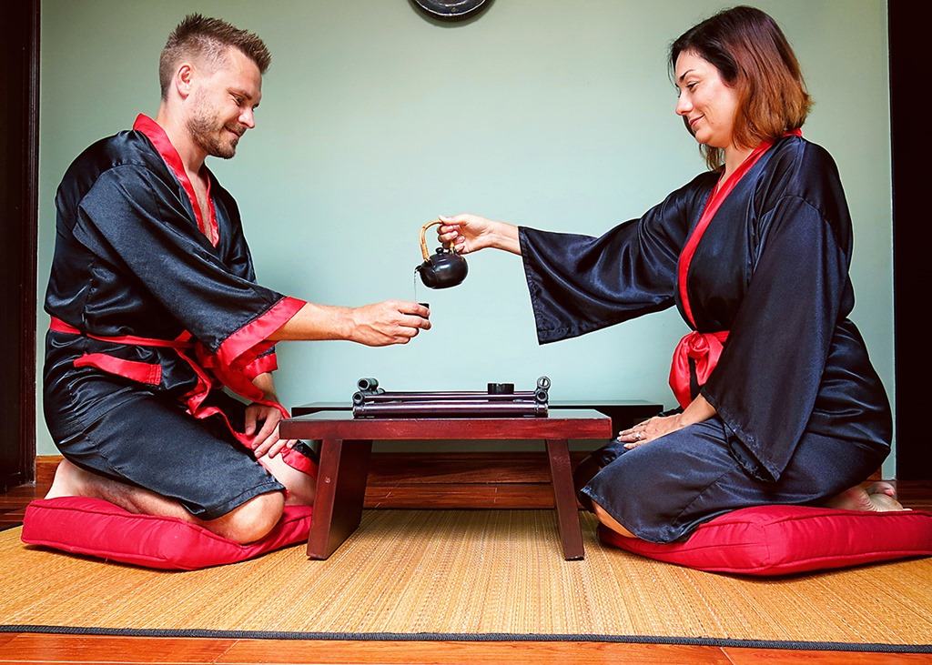 Victoria Hoi An, Vietnam, man and woman drining tea, traditional japanese setting