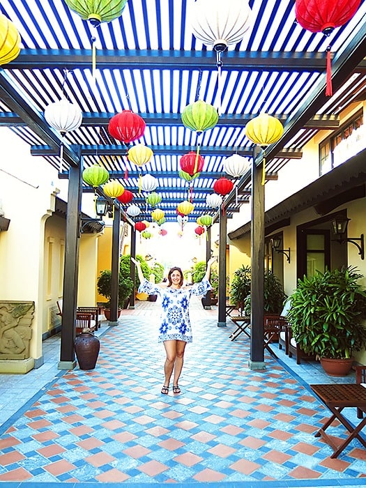 Victoria Hoi An, Vietnam, woman posing with arms up, colourful lanterns hanging above