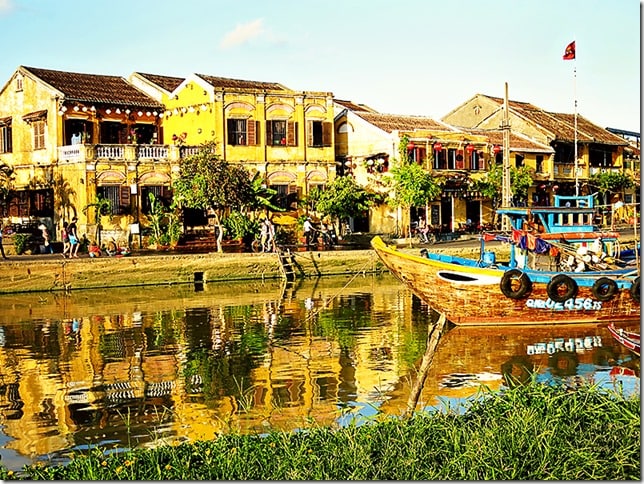 Hoi An Ancient Town Wanderlust Storytellers, Hoi An Vietnam, view of the river and buildings, yellow, boat 