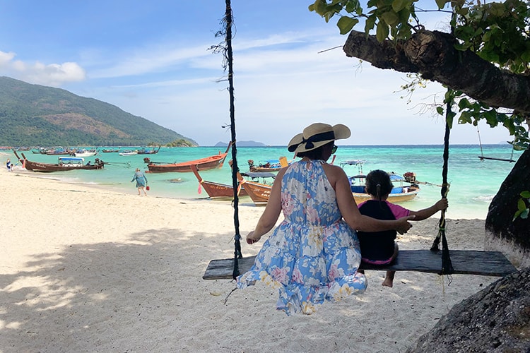 Summer Holiday Packing List, mother and daughter on a beach swing, Koh Lipe, Thailand