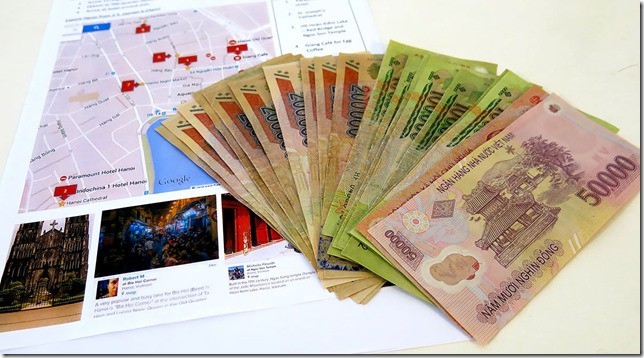 Vietnamese Money spread out on the table, map of a city