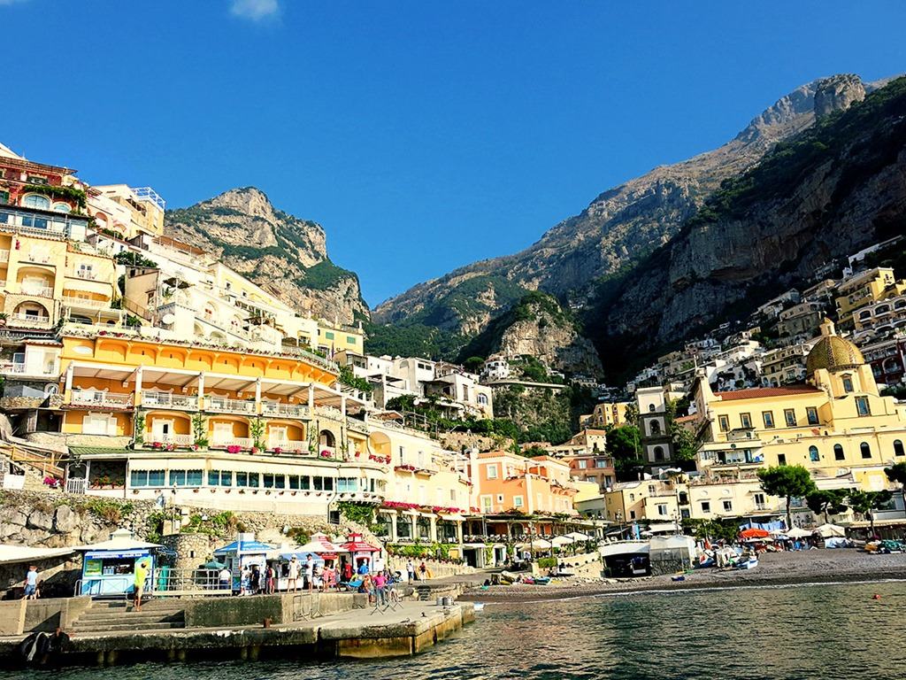 Positano Amalfi Coast, Italy, view form the water of the pier, beach, restaurants and accommodation all the way up the mountains