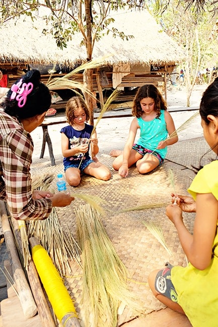 Kids learning how to make brooms with locals 
