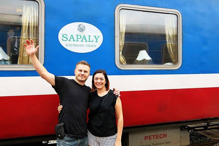 How to get from Hanoi to Sapa: Sapa Express Bus vs. Sapaly Express Train, man and woman standing in front of the train