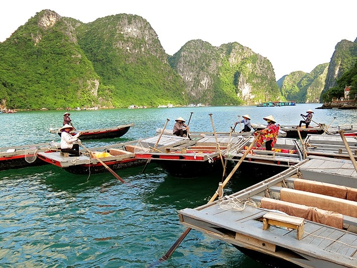 Local people from the Halong Bay fishing village, Vietnam, boats, triangle hats, rocky islands
