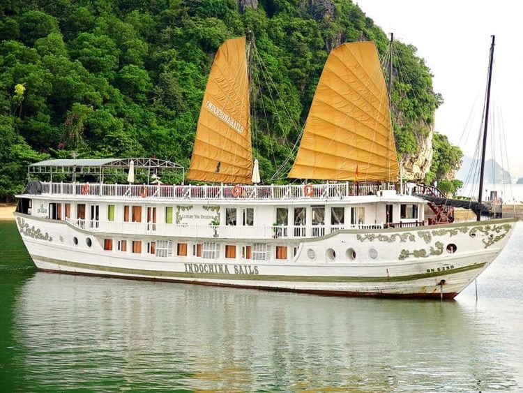 Halong Bay Vietnam junk boat, white boat with two yellow sails.