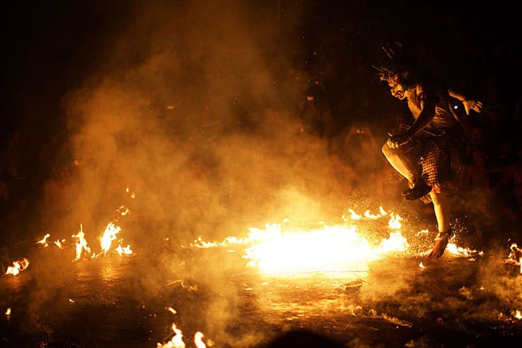 Traditional Balinese Kecak dance at Ulluwatu, fire on the ground, person dancing