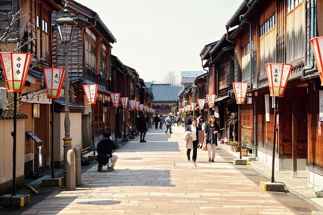 What to do in Kanazawa - Higashi Chaya District, Japan, people walking in the street, red lanterns, brown buildings