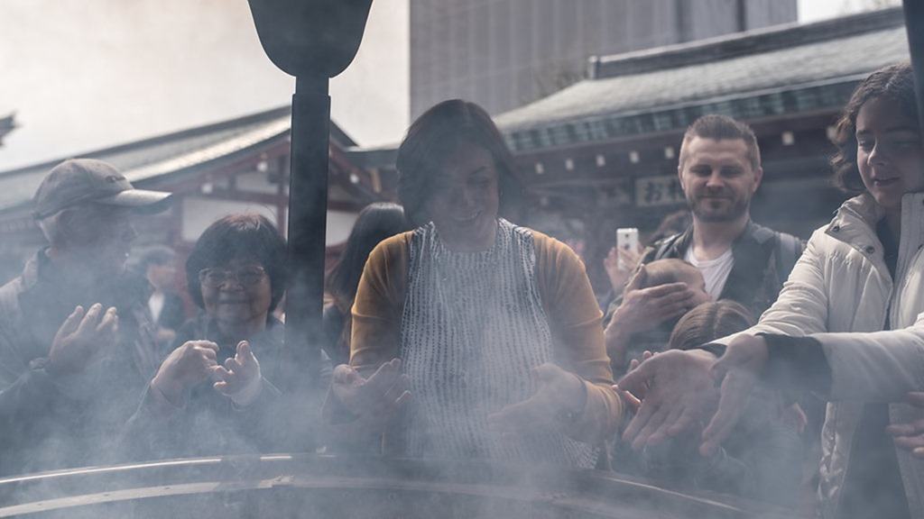 Senso-ji Temple Tokyo, people gathering around the smoky inscents burning 
