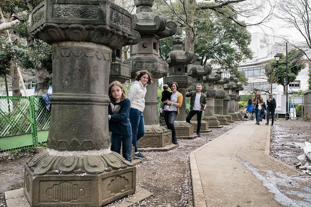 Ueno Park Cherry Blossom - family posing from behind the statues