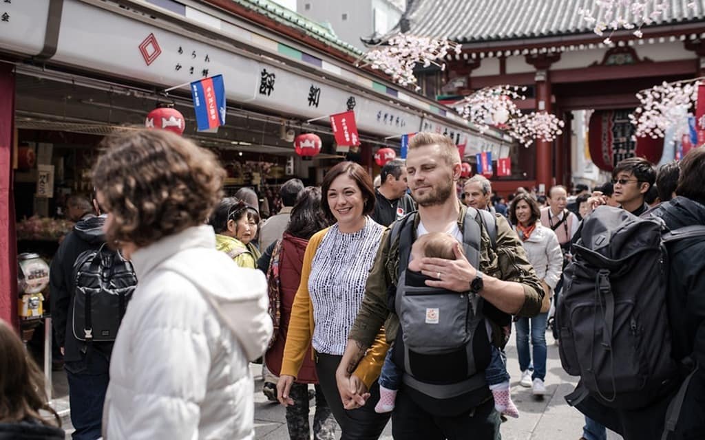 Senso-ji Temple Markets, family walking in the street smiling, baby in a baby carrier