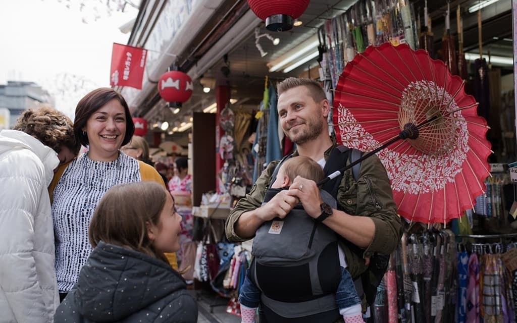 Senso-ji Temple Markets, man with red umbrella smiling, woman smiling, kids 