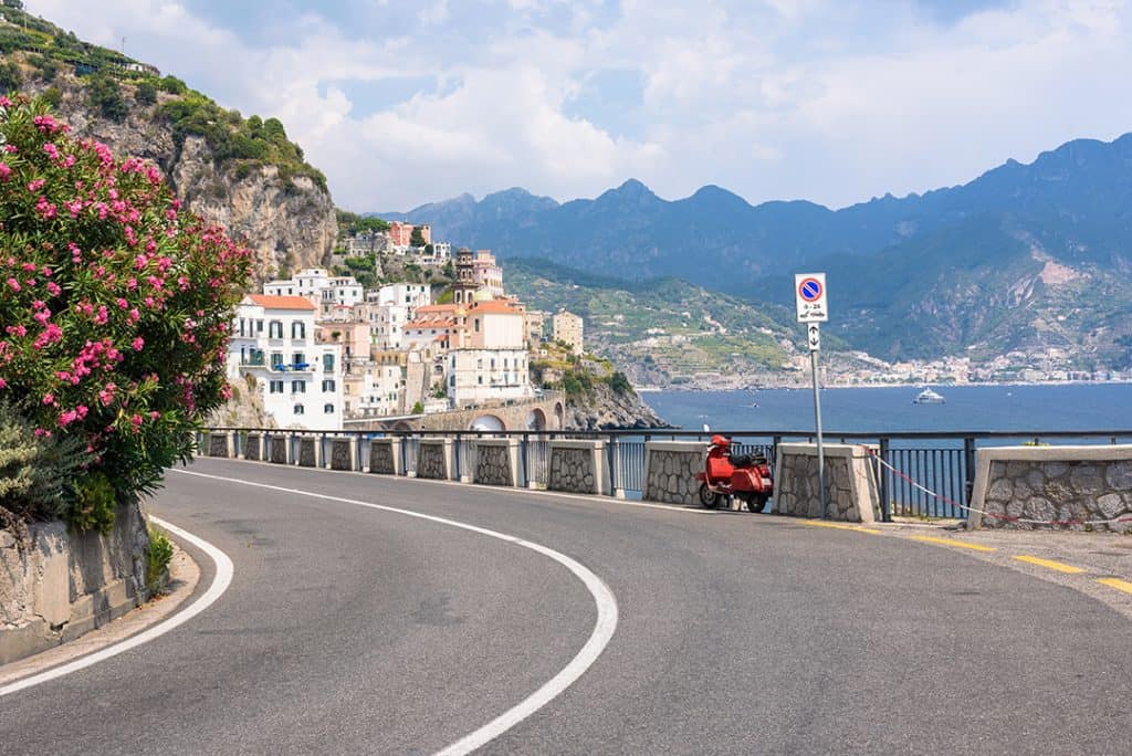 Street in Amalfi Coast, one scooter on the curve, buildings