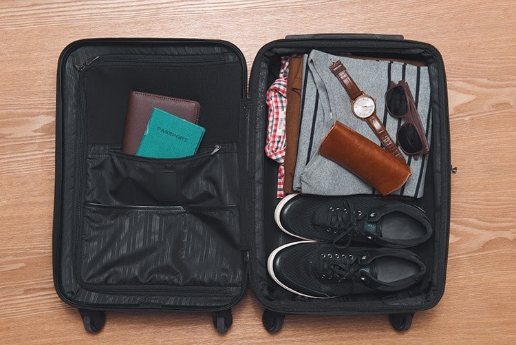Travel and vacations concept. Open traveler's bag with clothing and accessories.