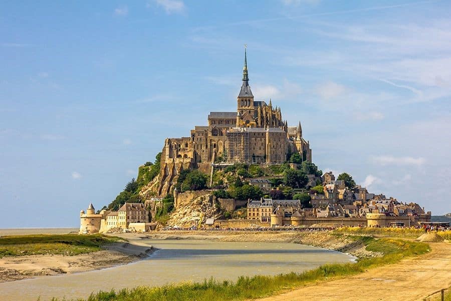 Mont Saint Michel, Normandy, France, town and cathedral on the mountain, river leading to the mountain