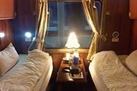 Cabin on the train, two beds, lamp stand, open window