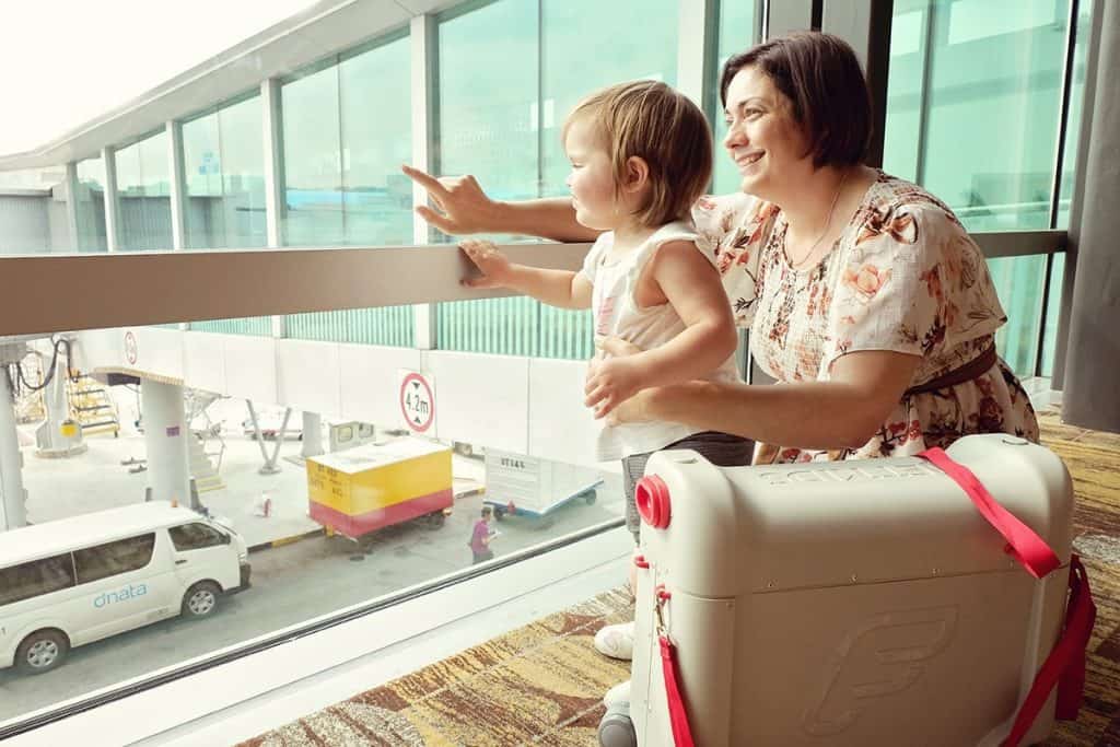 Mom and daughter waiting to board plane in airport 