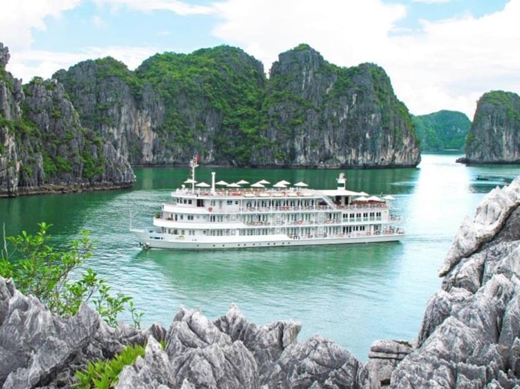 White cruise boat on the water in Halong Bay, Vietnam, rocky islands