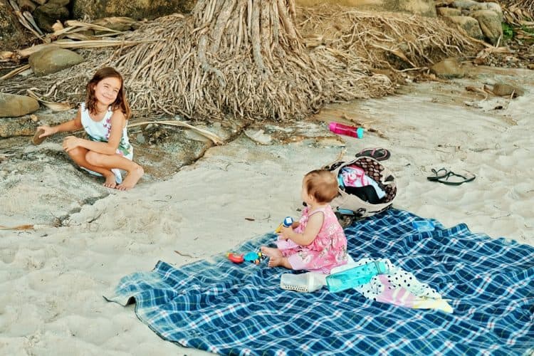 Beach and Baby, baby sitting on a beach blanket at the beach