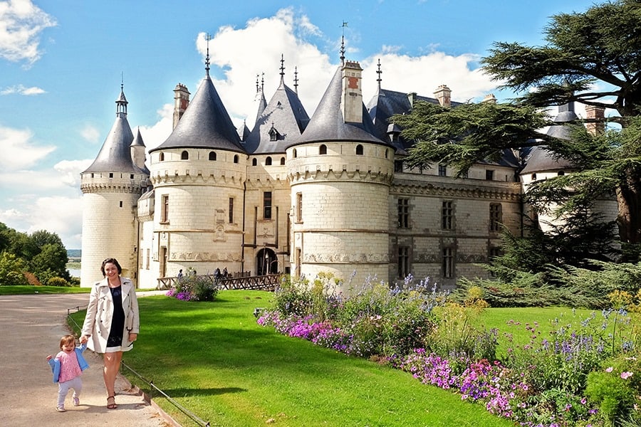 Chateau in Loire Valley, France, woman and toddler walking, castle and gardens in the background