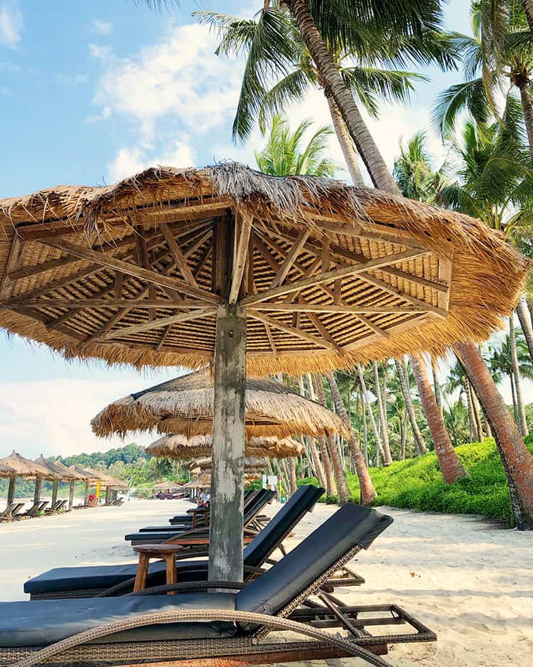 Bintan Resorts Club Med Beach, sun loungers, and beach umbrellas, palm trees