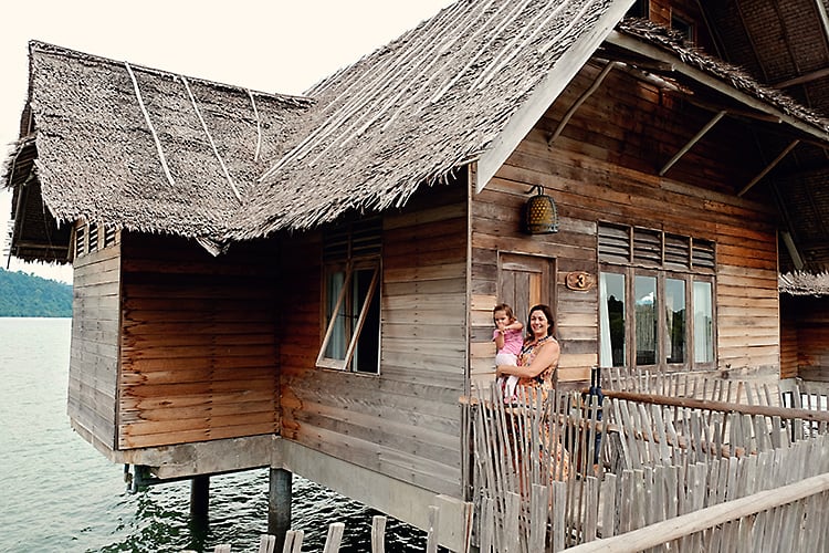 Telunas Private Island, Indonesia, mother and a toddler standing next to an over water villas