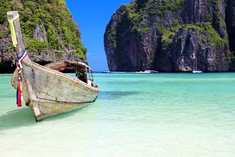 Phi Phi island, Thailand, view from the beach, longtail boat, rocky inlet