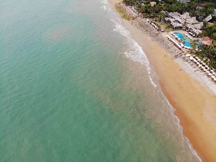 Bang Niang Khao Lak, Thailand, aerial view of the coast, beach and a resort with a pool, buildings and beach umbrellas