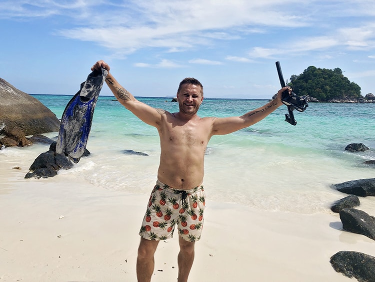 Koh Lipe Snorkelilng, man holding snorkelling gear in Thailand