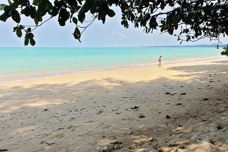 best Khao Lak beaches, one person walking on the beach, light blue water