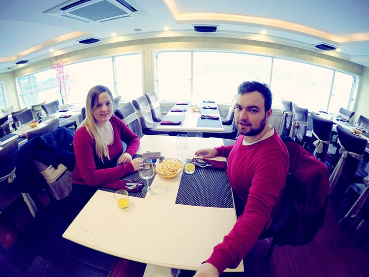 Princess Halong Bay Cruise, man and woman dressed in red in the dining area on the boat, selfie at the table