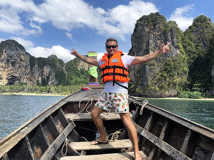 man standing on the boat with scenic view