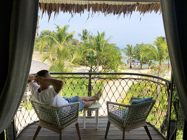 Patio Views from Treehouse Villas Thailand, man sitting on the chair relaxing