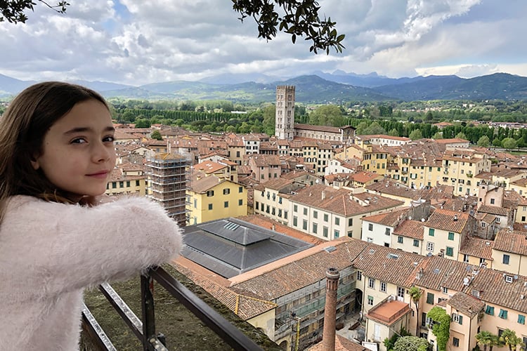 towns near florence italy - Lucca, Italy, view from the top, young girls looking out, rooftops and tower, mountains in the distance