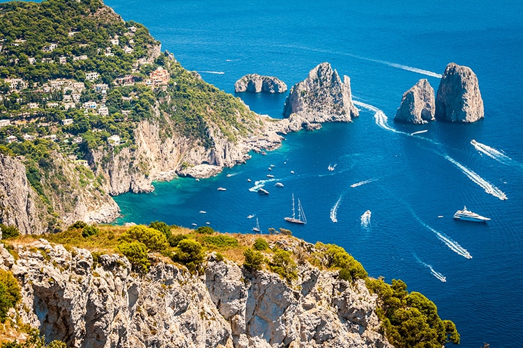 Capri Island view point, Italy, boats and rocky coastline, rocky arch in the water