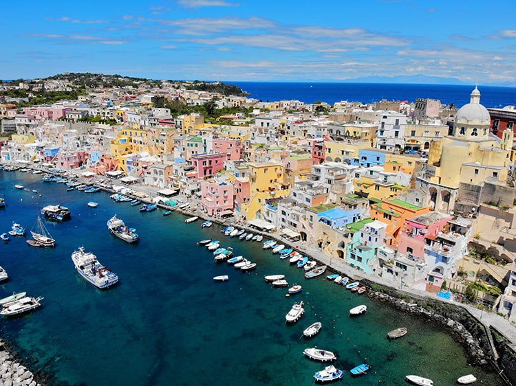 Marina Corricella on Procida Island, Italy, view of the marina from above, fishing boats and colourful buildings in the town
