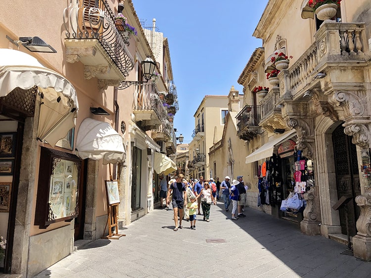 Taormina Sicily, Italy, foot path, walking street in the old town, old two and three story buildings with shops and balconies
