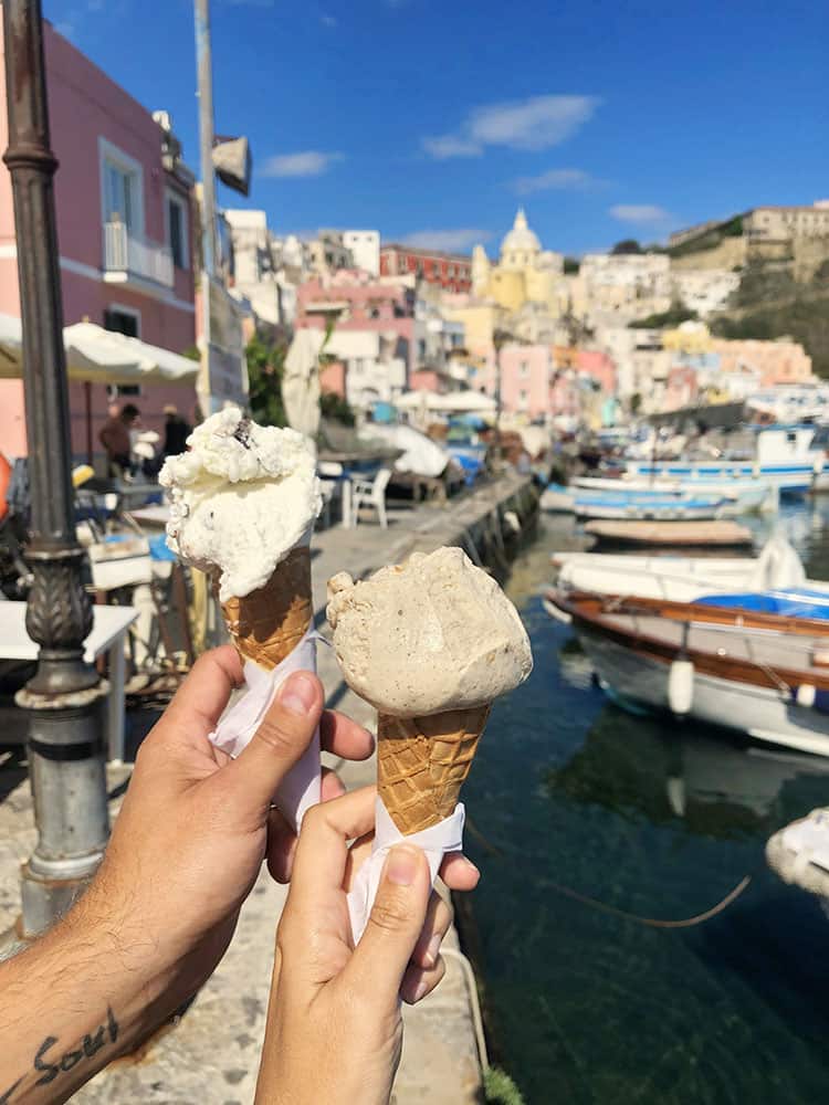 Best things to do in Procida, ice cream, gelato in two cones, Marina Coricelli in background