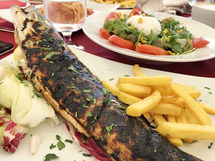 Fuego Ristorante Pizzeria, Procida, Italy, grilled whole fish with chips and salad