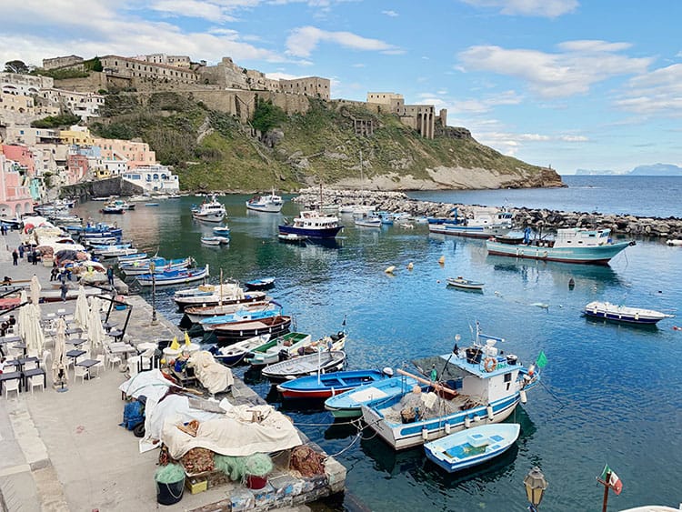 Palazzo D/Avalos, Procida in Italy, Marina with fishing gear, fishing boats and in the distance on the hill, the palazzo