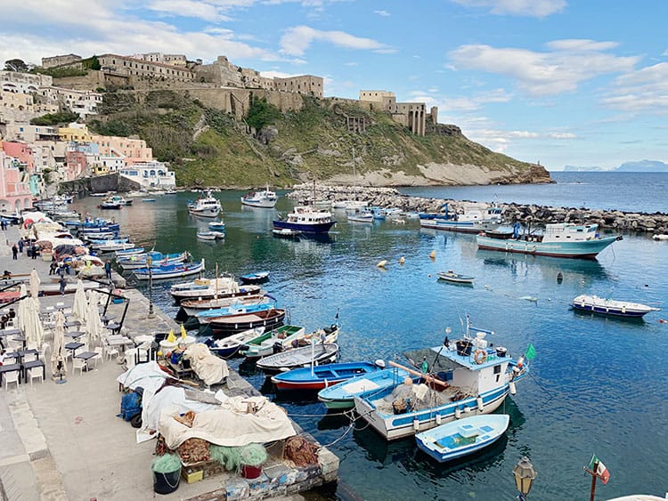 Palazzo D/Avalos, Procida in Italy, Marina with fishing gear, fishing boats and in the distance on the hill, the palazzo