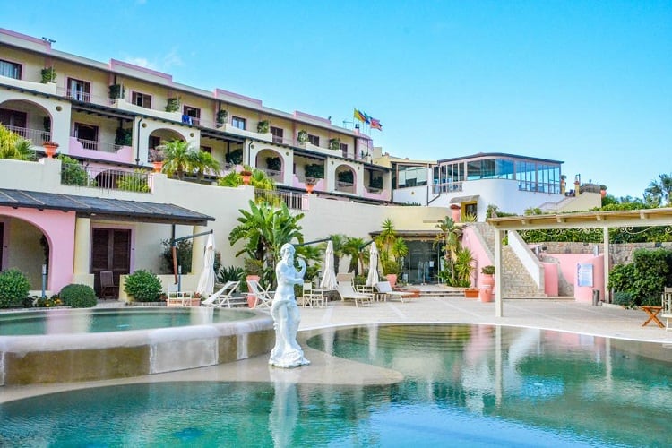 Hotel Tritone - Best Accommodation in Lipari, Italy, statue in the middle of the large pool, hotel in background