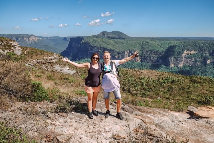 Two people, a couple standing on top of the mountain in Blue Mountains, NSW, Australia, baby in the baby carrier