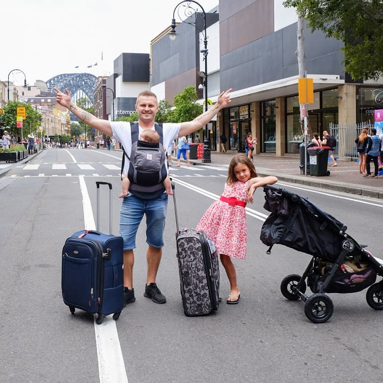 People in the street with luggage, Sydney Harbour Bridge, Australia