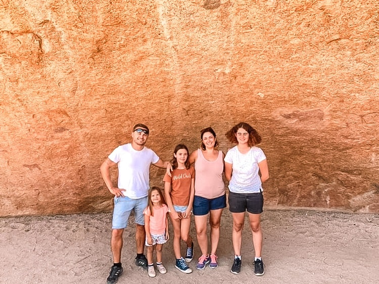 Check out the ancient paintings - family posing in front of a cave Spitzkoppe - Namibia